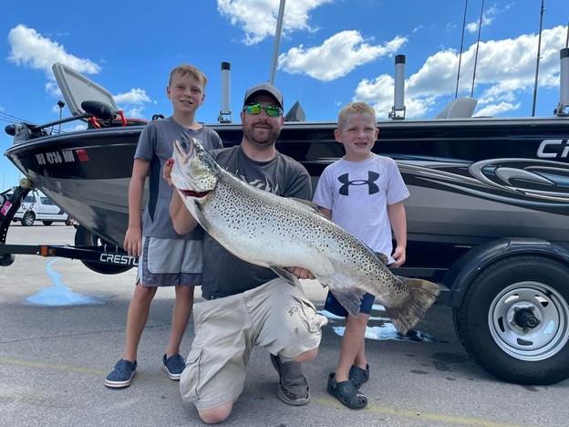 Dustin Groh with Boys and a 32 lb. Brown Trout